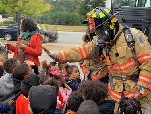 Firefighter with group on children